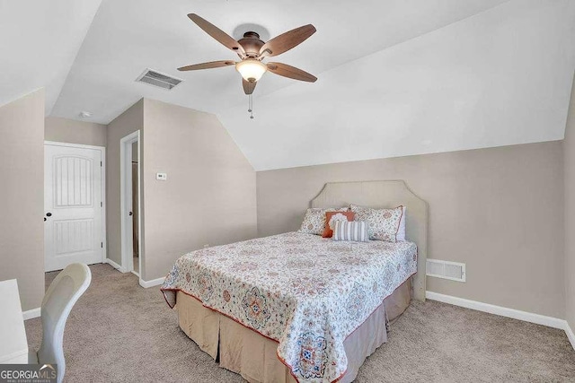 bedroom featuring lofted ceiling, ceiling fan, and light carpet