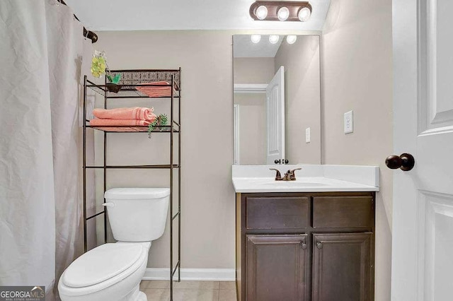 bathroom featuring toilet, tile patterned floors, and vanity