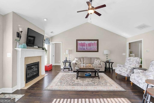 living room with lofted ceiling, a fireplace, dark wood-type flooring, and ceiling fan