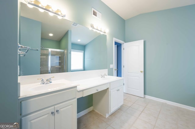 bathroom with tile patterned flooring, a shower with door, and vanity