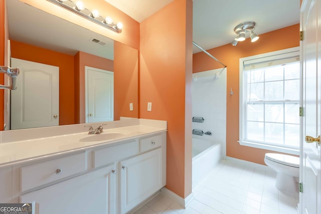 full bathroom featuring tile patterned flooring, bathtub / shower combination, vanity, and toilet