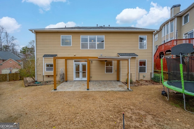 rear view of house featuring a patio, french doors, and a trampoline