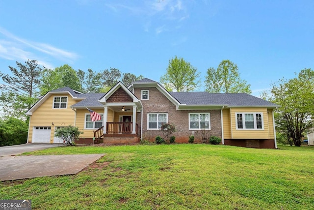 view of front of home featuring a porch, a front yard, and a garage