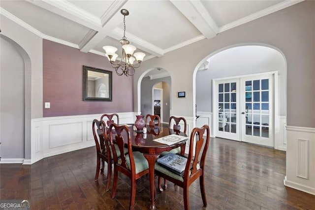 dining area featuring dark hardwood / wood-style flooring, french doors, an inviting chandelier, and beamed ceiling