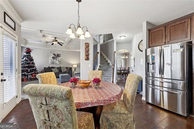 dining space with coffered ceiling, ceiling fan with notable chandelier, a wealth of natural light, and dark wood-type flooring