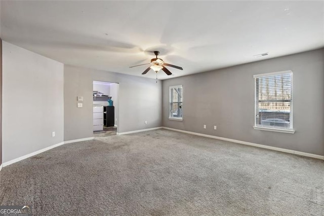 carpeted empty room featuring ceiling fan