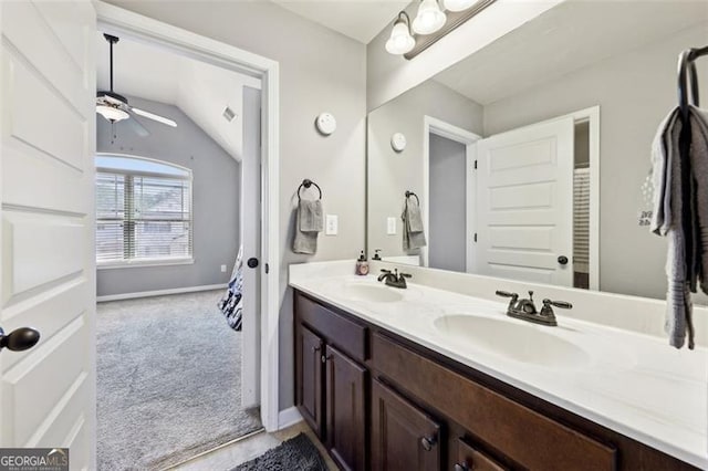 bathroom featuring ceiling fan, lofted ceiling, and vanity