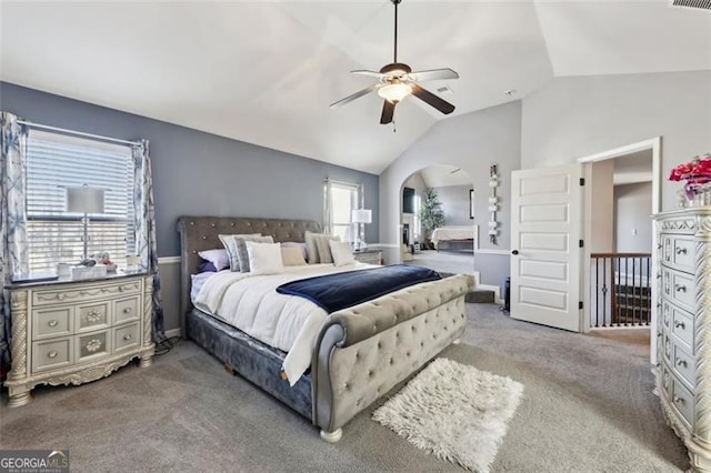 bedroom with ceiling fan, lofted ceiling, and carpet floors