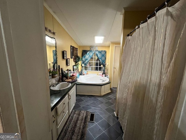 bathroom featuring a washtub and vanity