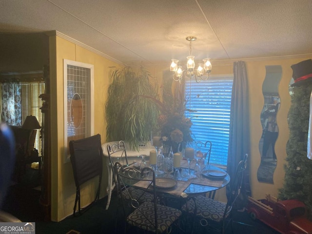 dining space with ornamental molding, a textured ceiling, and a chandelier