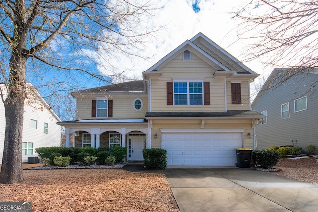 view of front of property featuring central AC unit and a garage