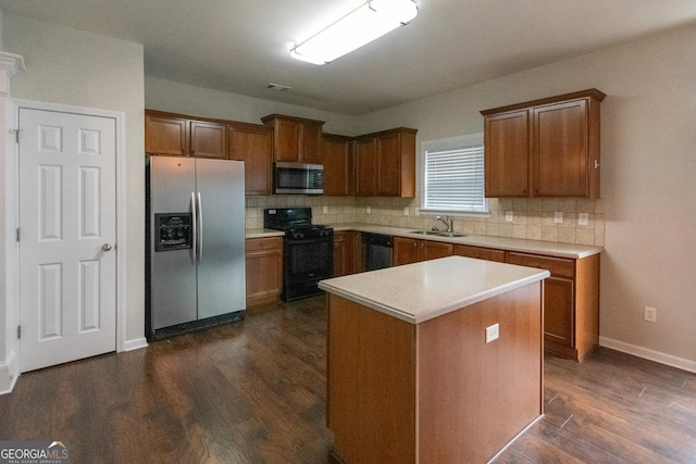 kitchen featuring a center island, stainless steel appliances, backsplash, dark hardwood / wood-style flooring, and sink