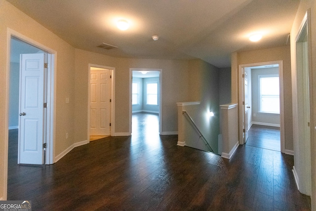 hall with dark wood-type flooring