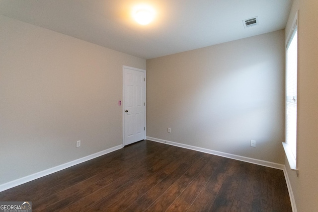 unfurnished room featuring dark hardwood / wood-style floors