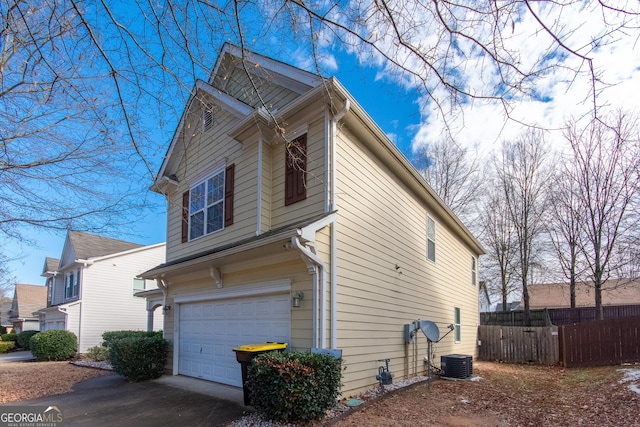 view of property exterior featuring central AC unit and a garage