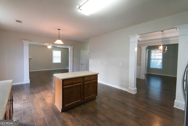 kitchen featuring hanging light fixtures, dark hardwood / wood-style flooring, plenty of natural light, and ceiling fan with notable chandelier