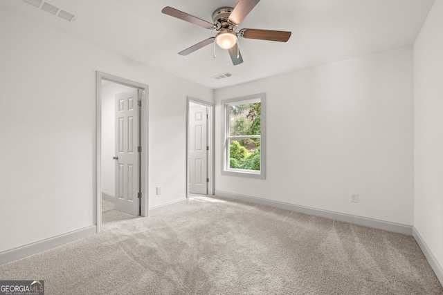 unfurnished bedroom with ceiling fan and light carpet