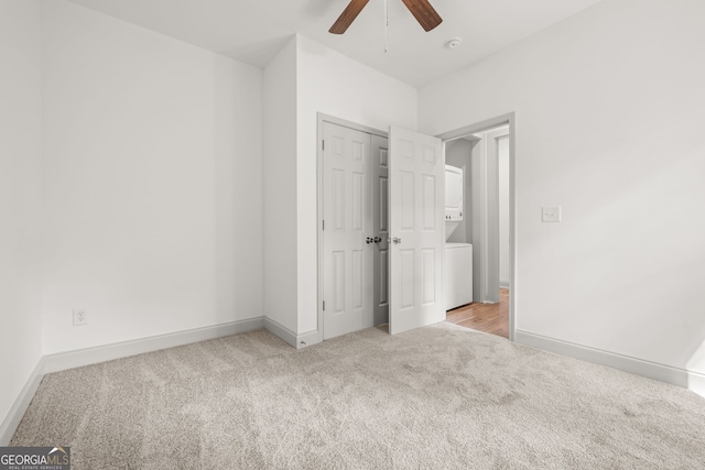 unfurnished bedroom with ceiling fan and light colored carpet