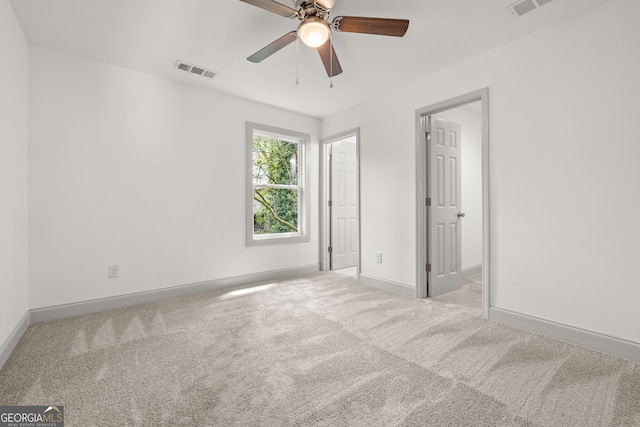 carpeted empty room with ceiling fan