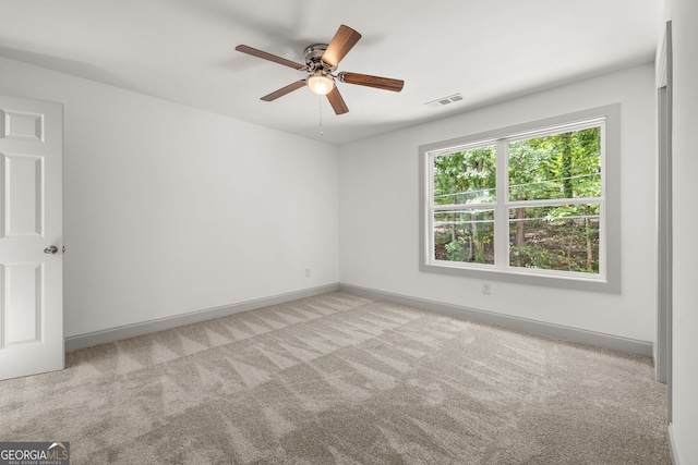 empty room with light carpet and ceiling fan