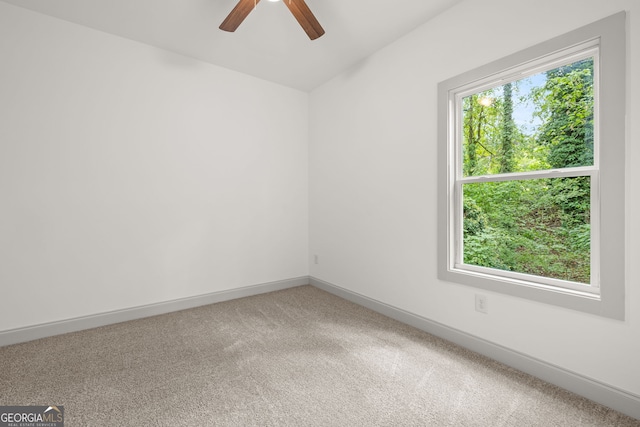 carpeted spare room with ceiling fan