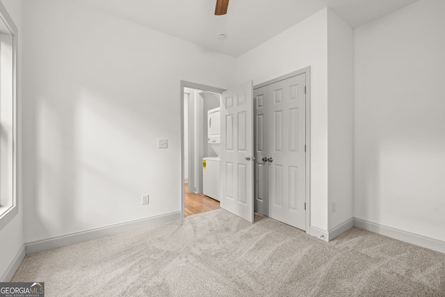 unfurnished bedroom with light colored carpet and ceiling fan