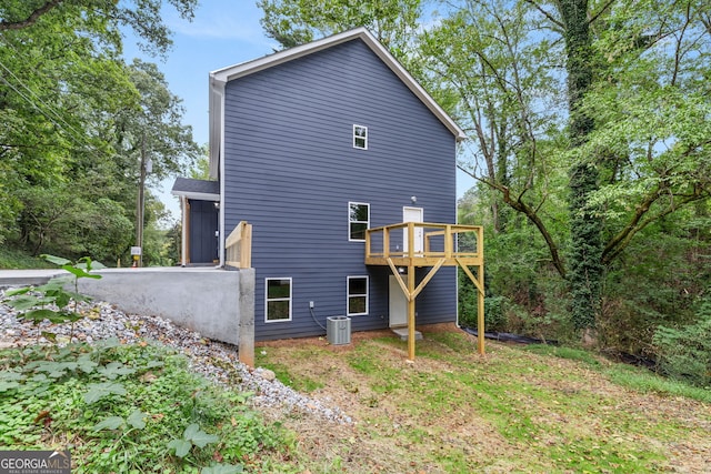 back of house with a deck and cooling unit