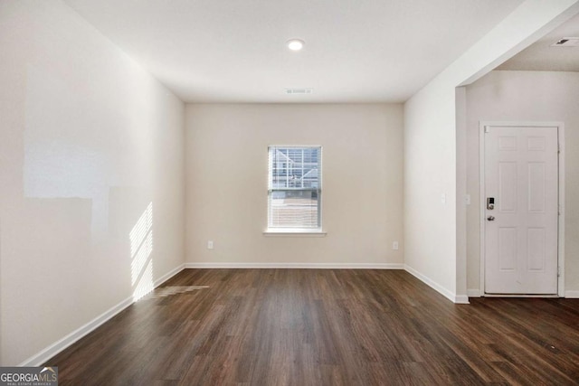 unfurnished room featuring dark hardwood / wood-style flooring