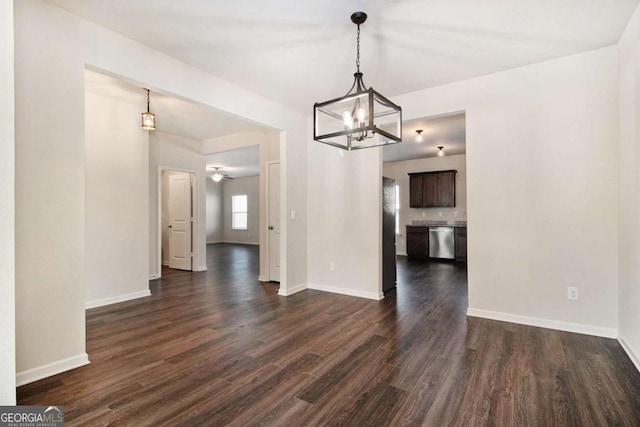 unfurnished dining area with dark hardwood / wood-style flooring and a chandelier