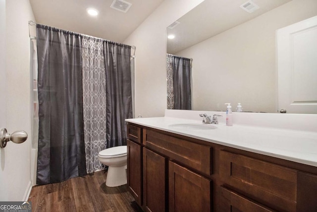 full bathroom featuring shower / tub combo with curtain, vanity, toilet, and hardwood / wood-style floors