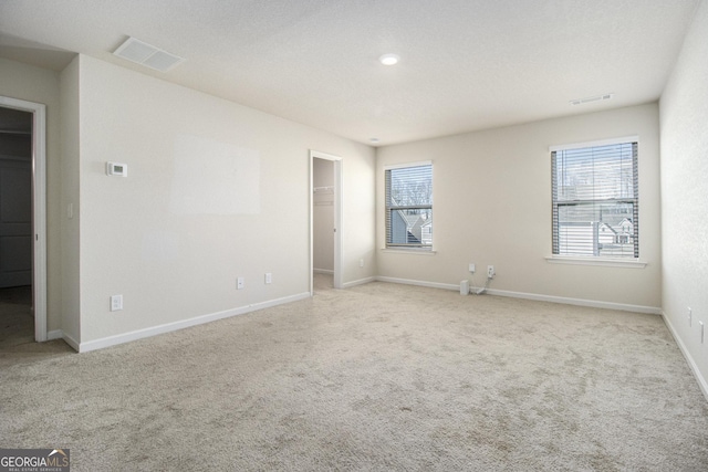 spare room featuring light colored carpet