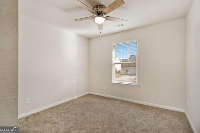 carpeted empty room featuring ceiling fan