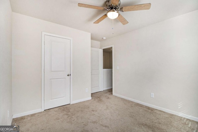 unfurnished bedroom featuring light carpet and ceiling fan