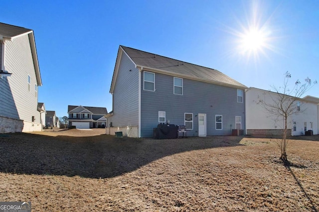 rear view of property featuring central air condition unit