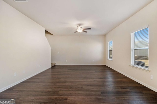 spare room with dark hardwood / wood-style floors and ceiling fan