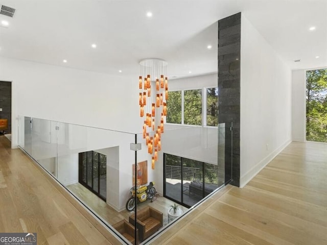 unfurnished living room featuring light hardwood / wood-style flooring and plenty of natural light