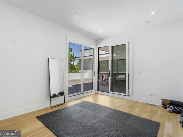 exercise room featuring hardwood / wood-style flooring