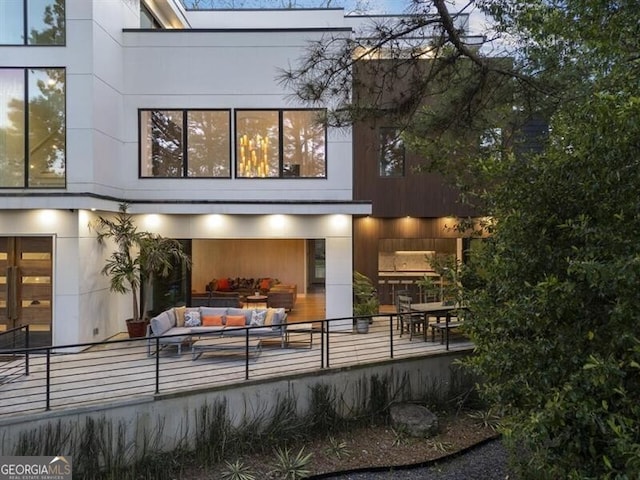 rear view of property featuring an outdoor living space