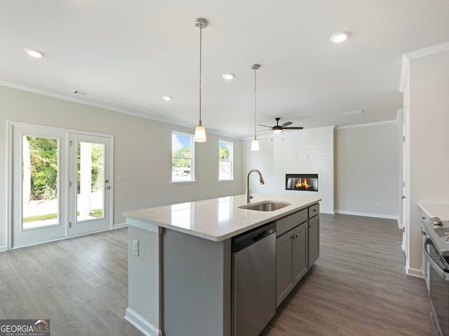 kitchen with a fireplace, gray cabinetry, appliances with stainless steel finishes, open floor plan, and a sink