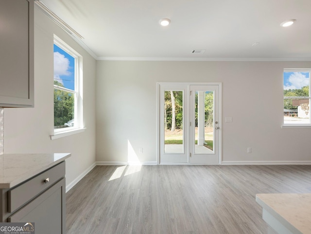 unfurnished living room featuring light wood finished floors, visible vents, baseboards, ornamental molding, and recessed lighting