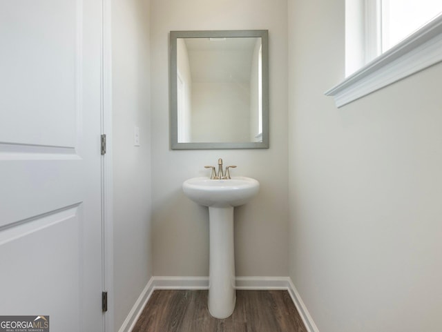 bathroom featuring wood finished floors and baseboards