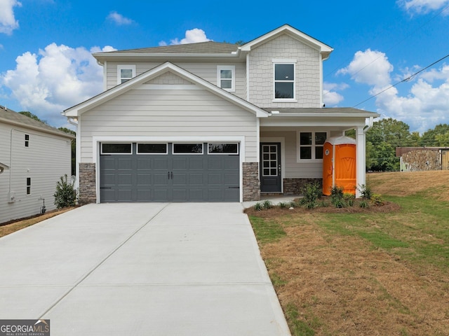 view of front of house featuring driveway, stone siding, and a front yard