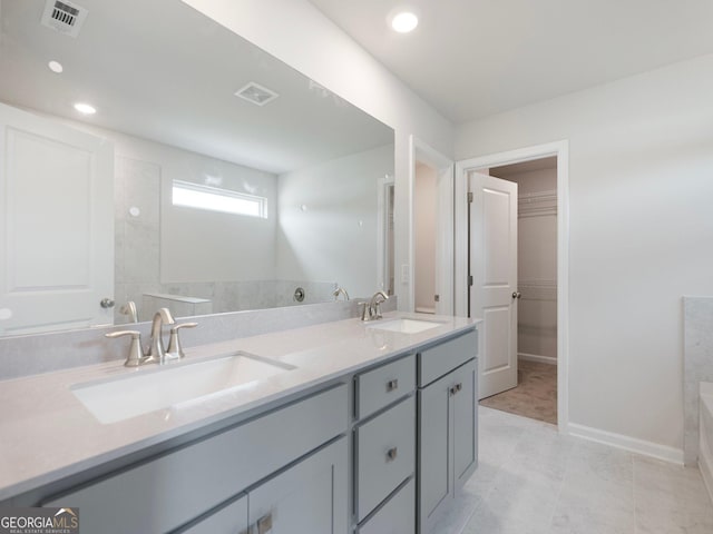 full bathroom featuring double vanity, visible vents, and a sink