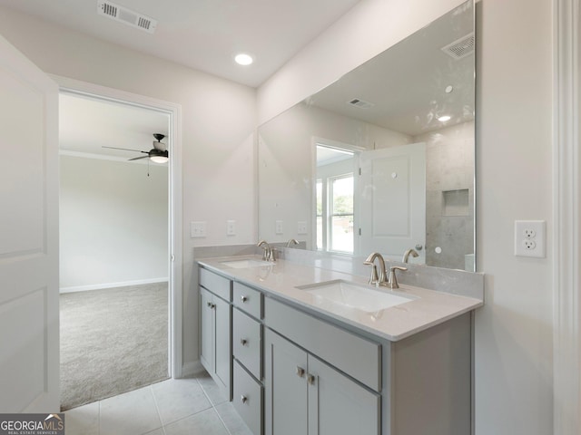 bathroom with tile patterned flooring, visible vents, a sink, and double vanity