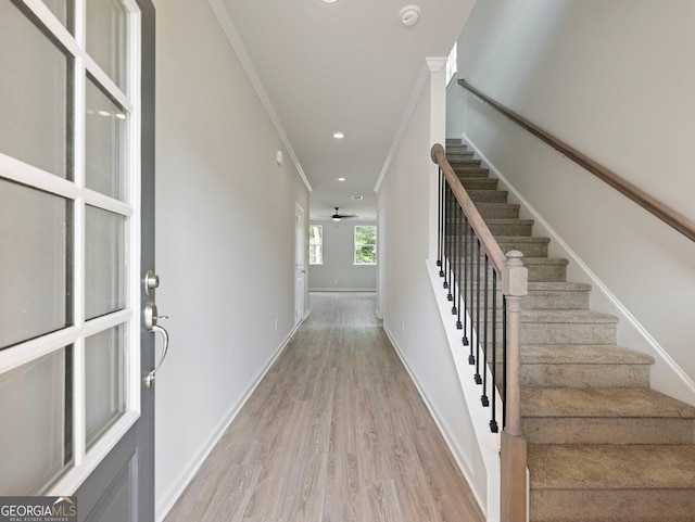 entrance foyer featuring light wood-style floors, baseboards, crown molding, and recessed lighting