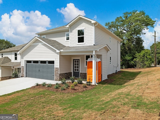 view of front of house featuring a front lawn, stone siding, an attached garage, and concrete driveway