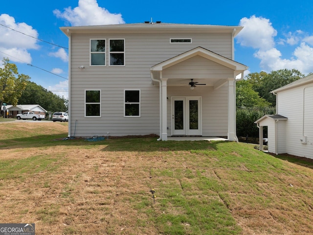 back of house featuring french doors, a lawn, and a ceiling fan