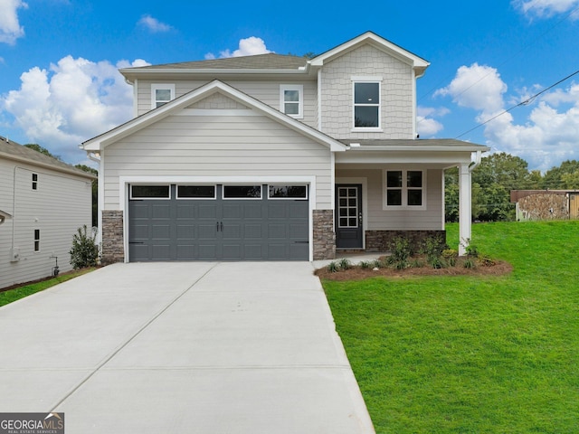 view of front of property with stone siding, a front yard, concrete driveway, and a garage