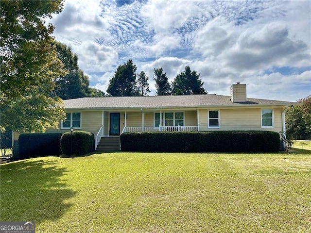 ranch-style home with a front yard and covered porch