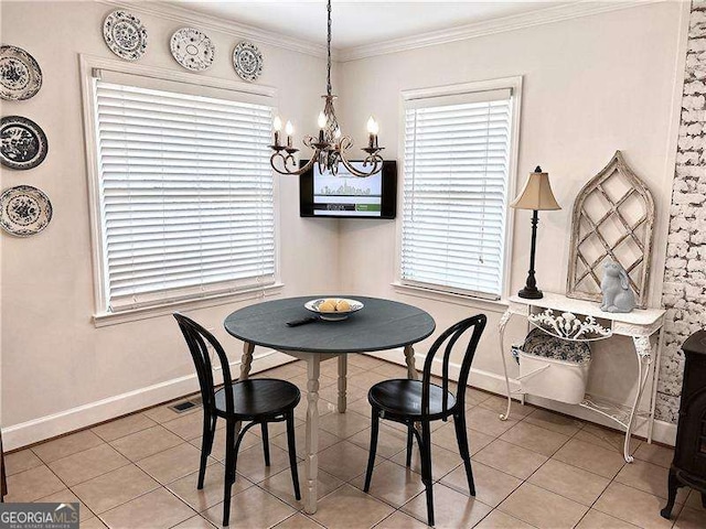 tiled dining area with an inviting chandelier and crown molding